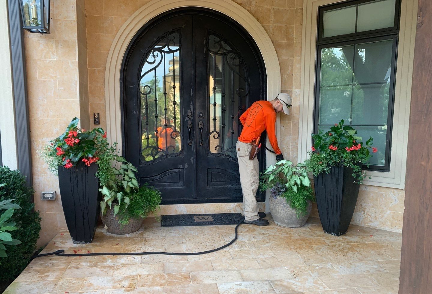watering container plant arrangements at the front entry