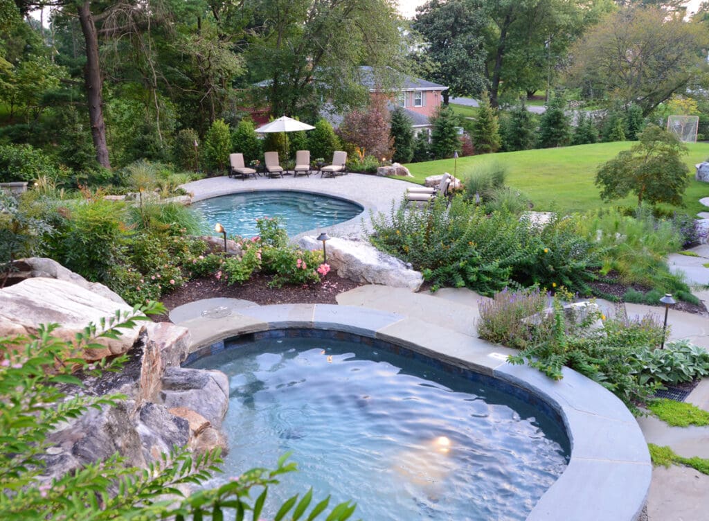 view over spa to swimming pool and sports field